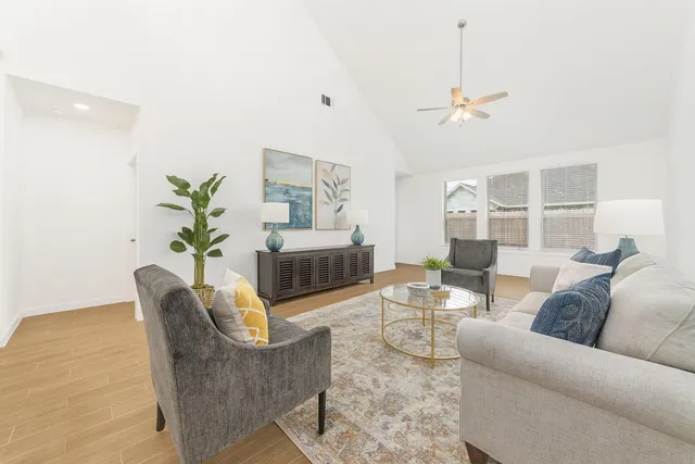 a living room with furniture potted plant and a chandelier