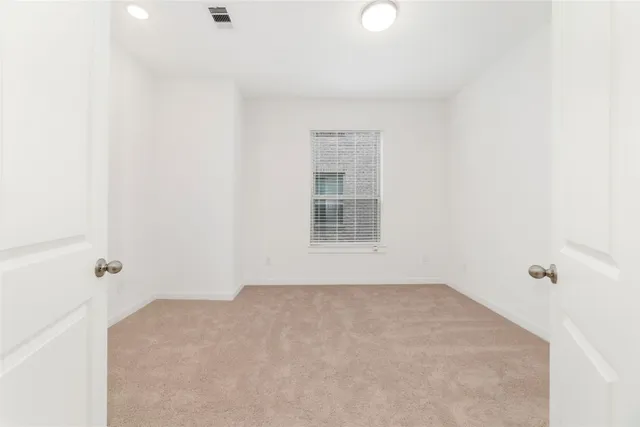 an empty room with windows and closet