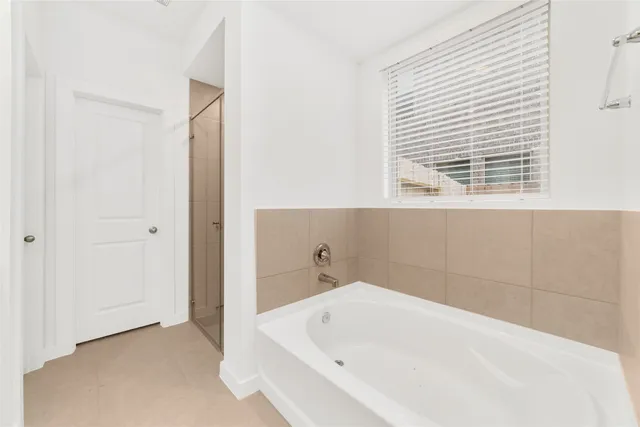 a bathroom with a bathtub and a shower