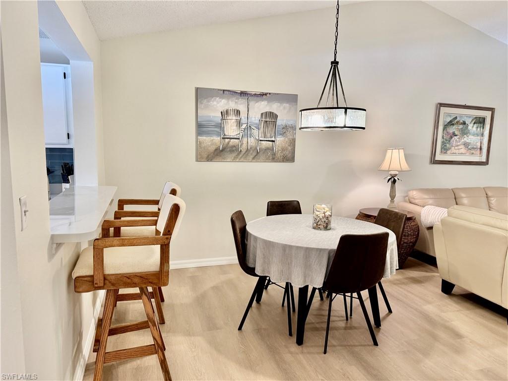 645 Squire Court, Unit 202 Naples, FL 34104 - Photo 13 of 41 a dining room with furniture and window