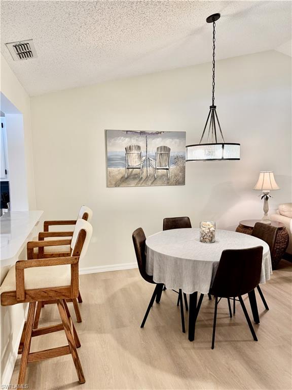 645 Squire Court, Unit 202 Naples, FL 34104 - Photo 14 of 41 a view of a dining room with furniture