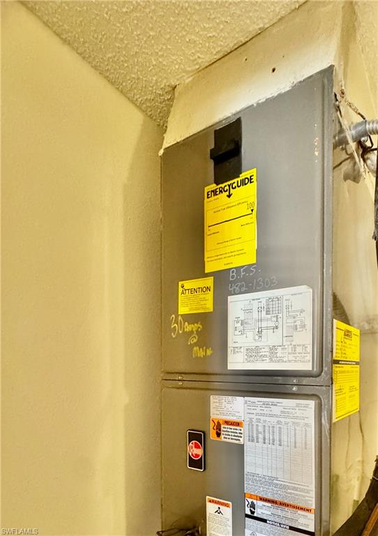 645 Squire Court, Unit 202 Naples, FL 34104 - Photo 16 of 41 a view of a brick wall with paintings on the wall