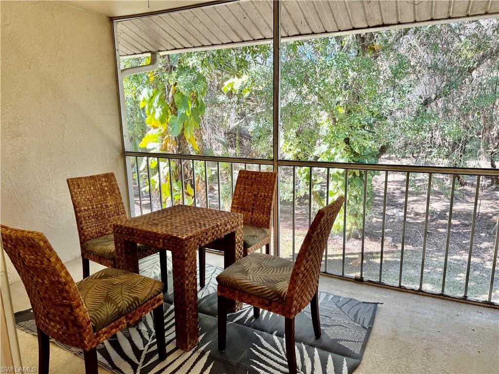 645 Squire Court, Unit 202 Naples, FL 34104 - Photo 19 of 41 a view of a chairs and table in patio
