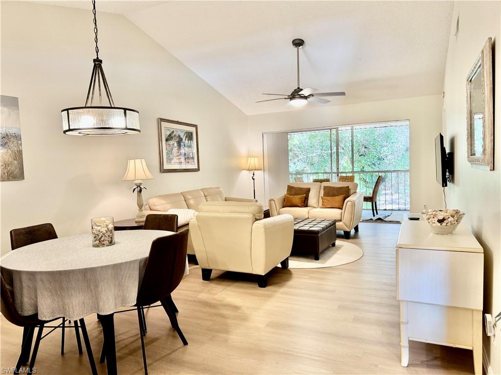 645 Squire Court, Unit 202 Naples, FL 34104 - Photo 20 of 41 a living room with furniture and a chandelier