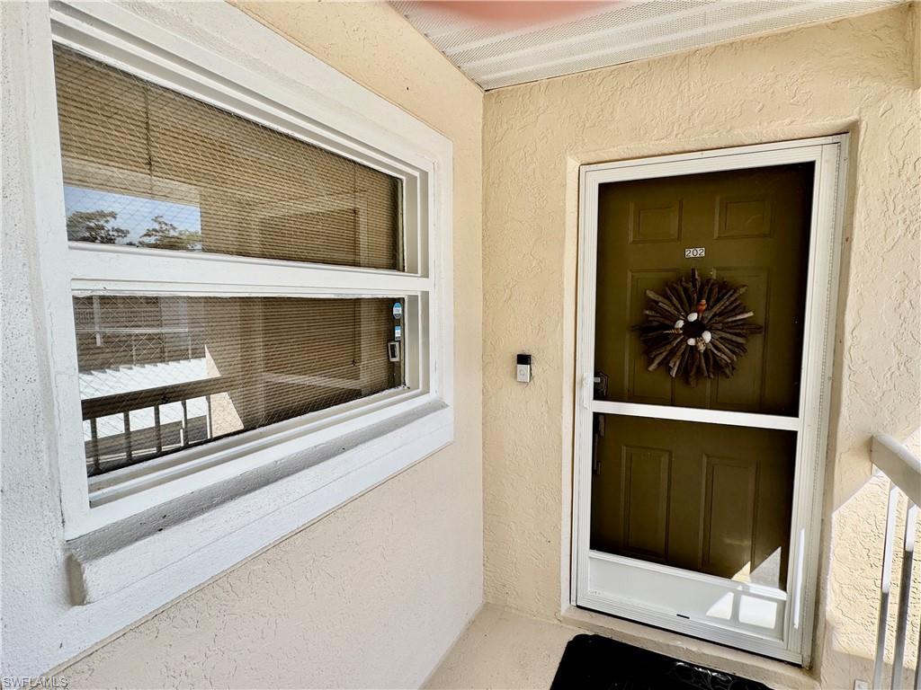 645 Squire Court, Unit 202 Naples, FL 34104 - Photo 2 of 41 a hallway with closet