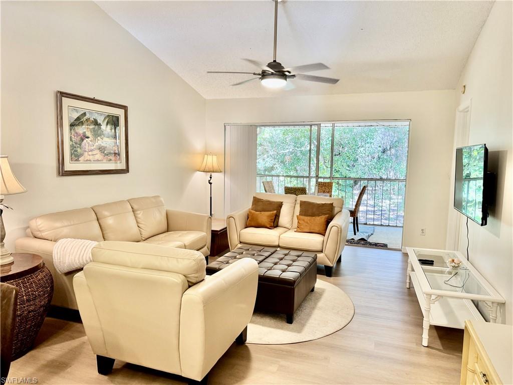 645 Squire Court, Unit 202 Naples, FL 34104 - Photo 21 of 41 a living room with furniture and a flat screen tv