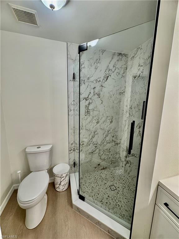 645 Squire Court, Unit 202 Naples, FL 34104 - Photo 22 of 41 a bathroom with a shower and a toilet