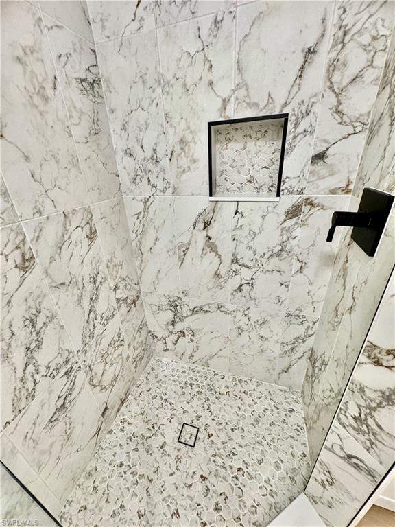 645 Squire Court, Unit 202 Naples, FL 34104 - Photo 26 of 41 a stone wall with a snow on the wall