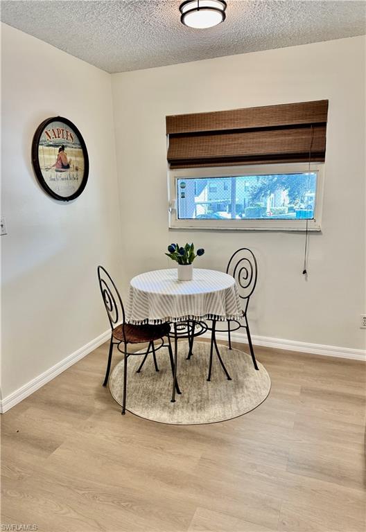 645 Squire Court, Unit 202 Naples, FL 34104 - Photo 3 of 41 a view of a dining room with furniture and wall paintings