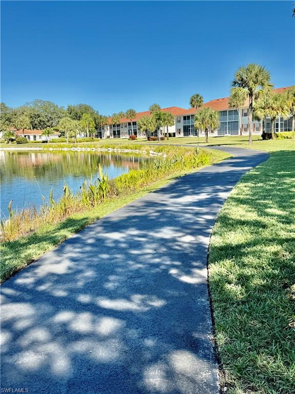 645 Squire Court, Unit 202 Naples, FL 34104 - Photo 39 of 41 a view of a lake with houses in the back