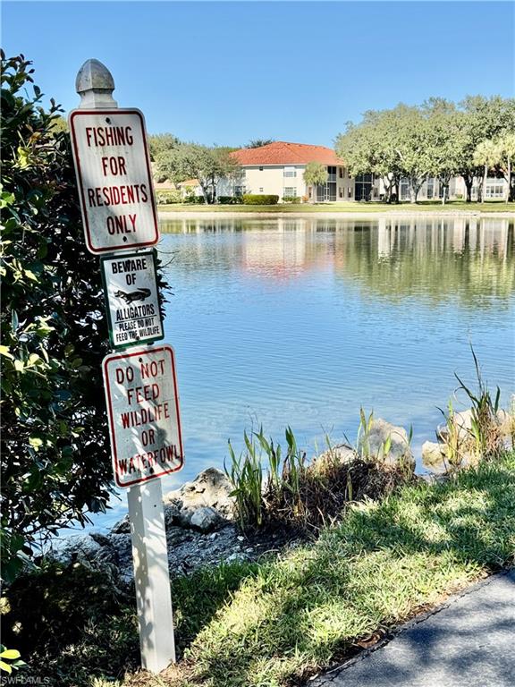 645 Squire Court, Unit 202 Naples, FL 34104 - Photo 40 of 41 a sign that is on a pole on the water