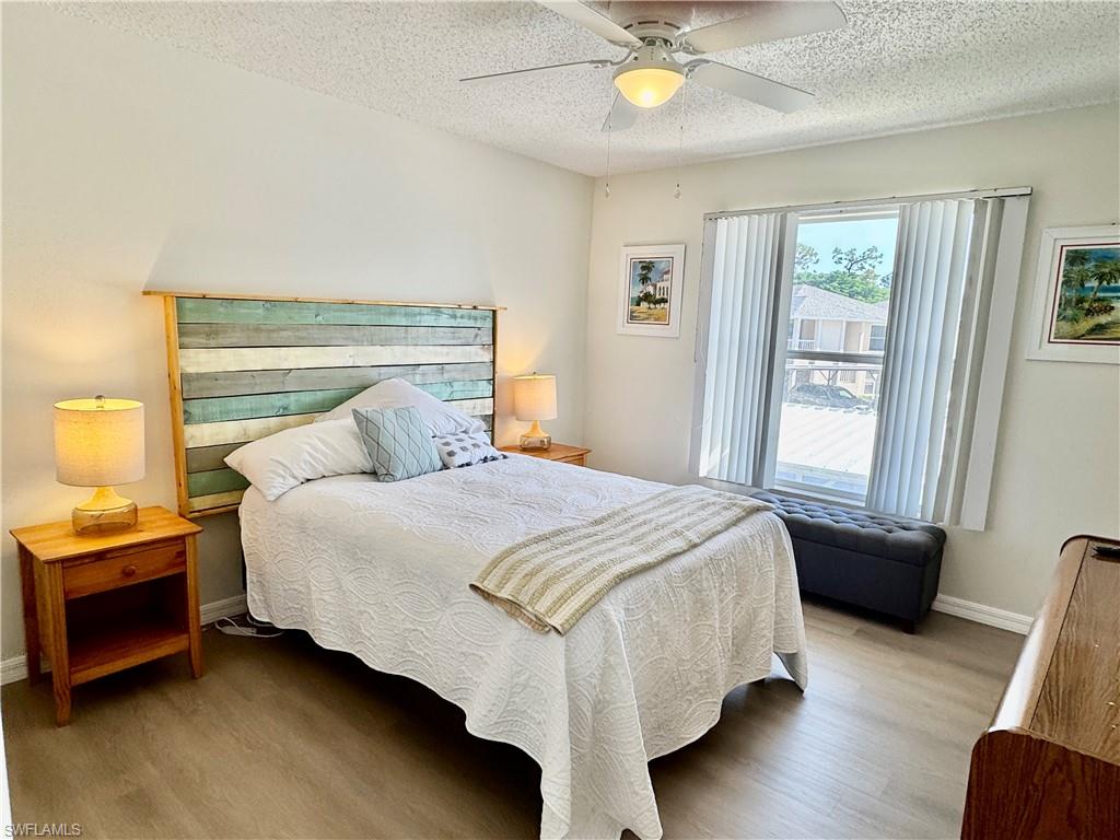 645 Squire Court, Unit 202 Naples, FL 34104 - Photo 9 of 41 a bedroom with a bed and window