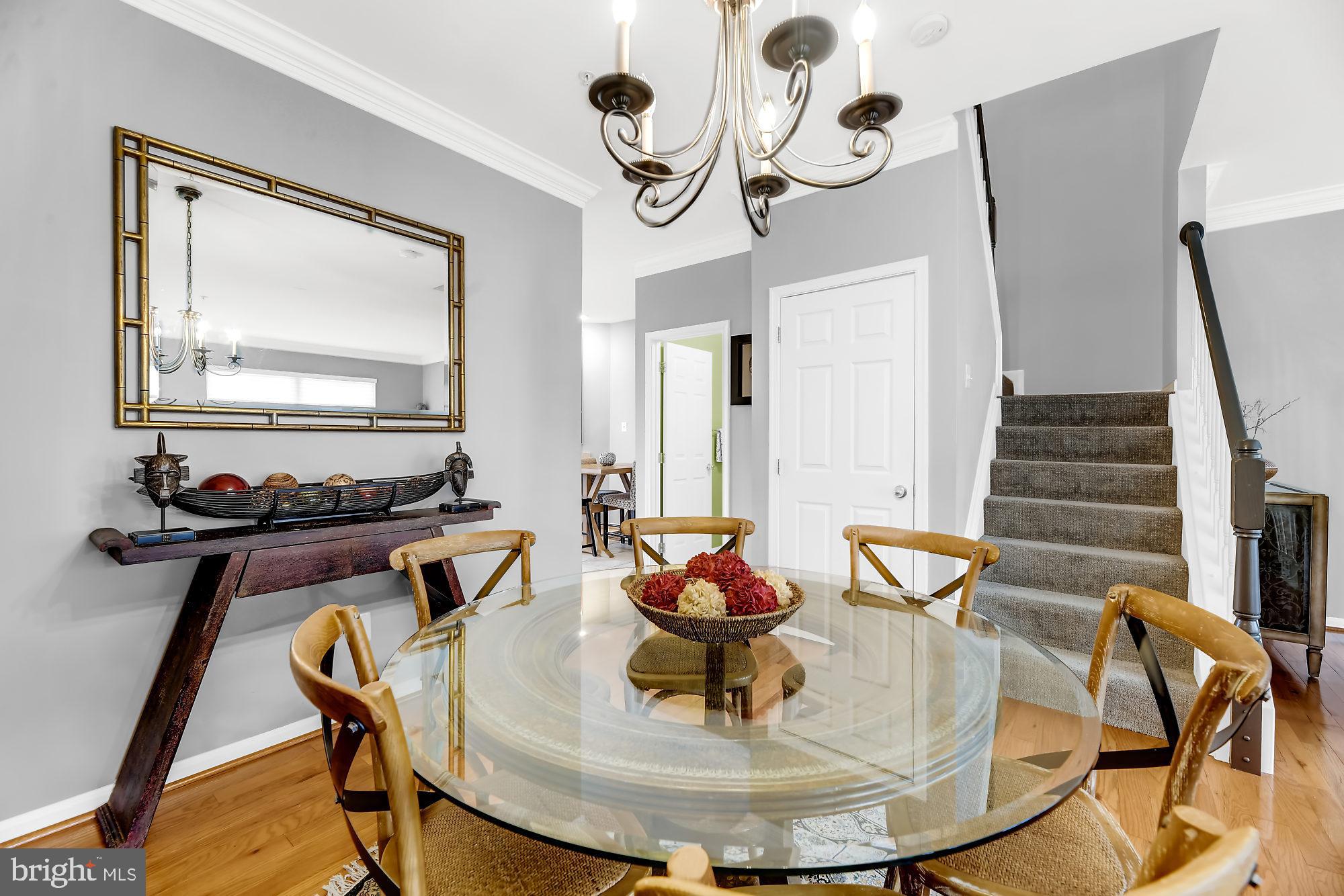 2090 Clipper Park Road Baltimore, MD 21211 - Photo 11 of 75 a view of a dining room with furniture wooden floor and a chandelier