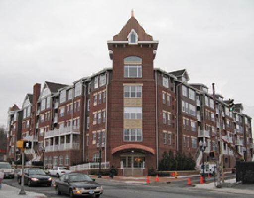 35 West Broad Street, Unit 128 Stamford, CT 06902 - Photo 1 of 1 a front view of a building with lot of cars and trees