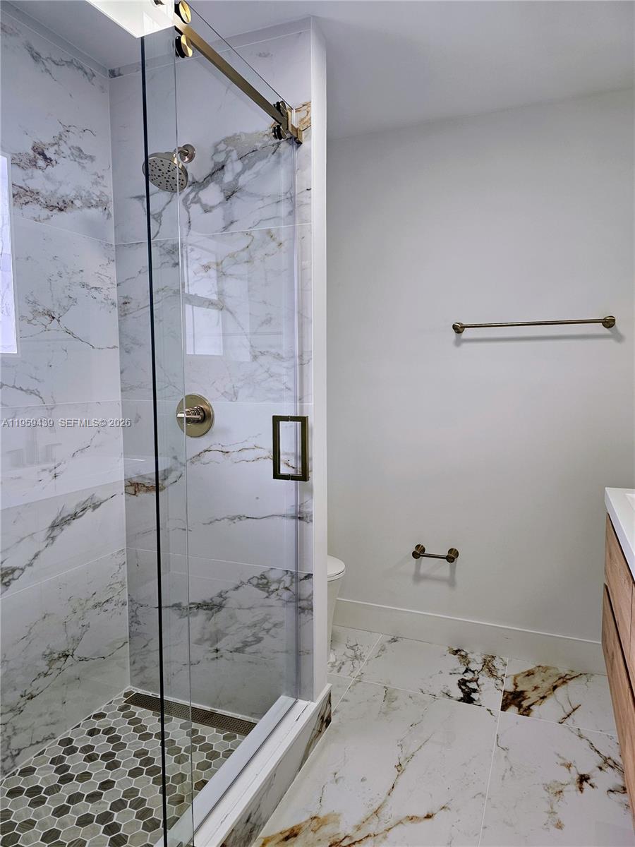 15581 Southwest 144th Court Miami, FL 33177 - Photo 12 of 37 a bathroom with a shower