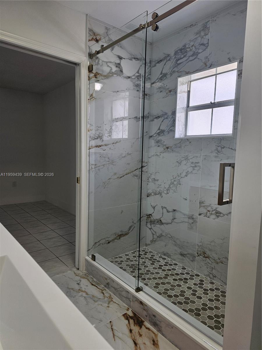 15581 Southwest 144th Court Miami, FL 33177 - Photo 13 of 37 a bathroom with a shower