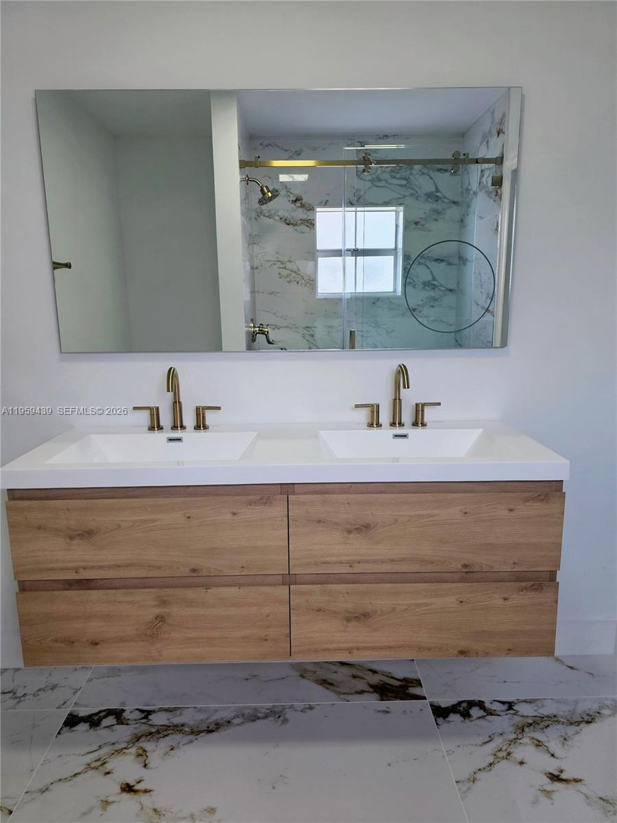 15581 Southwest 144th Court Miami, FL 33177 - Photo 15 of 37 a bathroom with a sink and a mirror