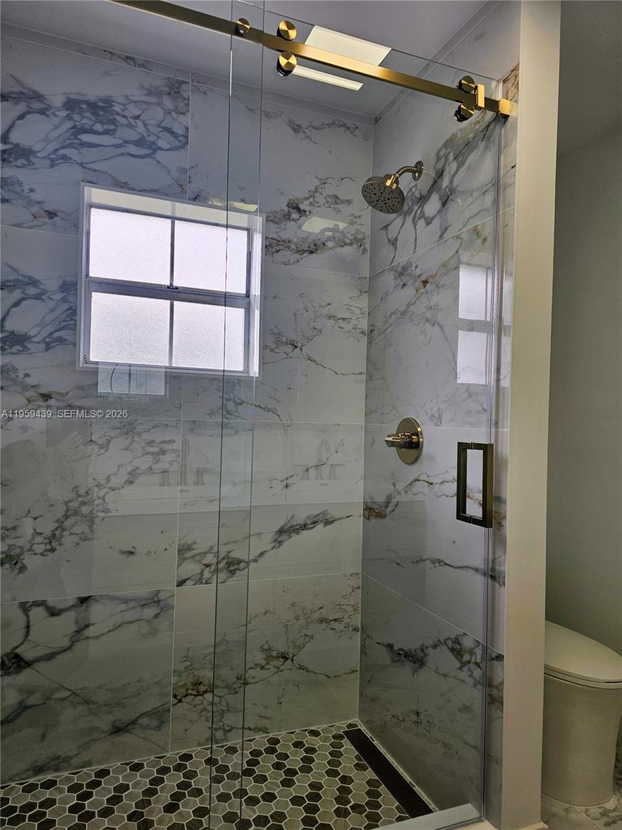 15581 Southwest 144th Court Miami, FL 33177 - Photo 16 of 37 a bathroom with a shower