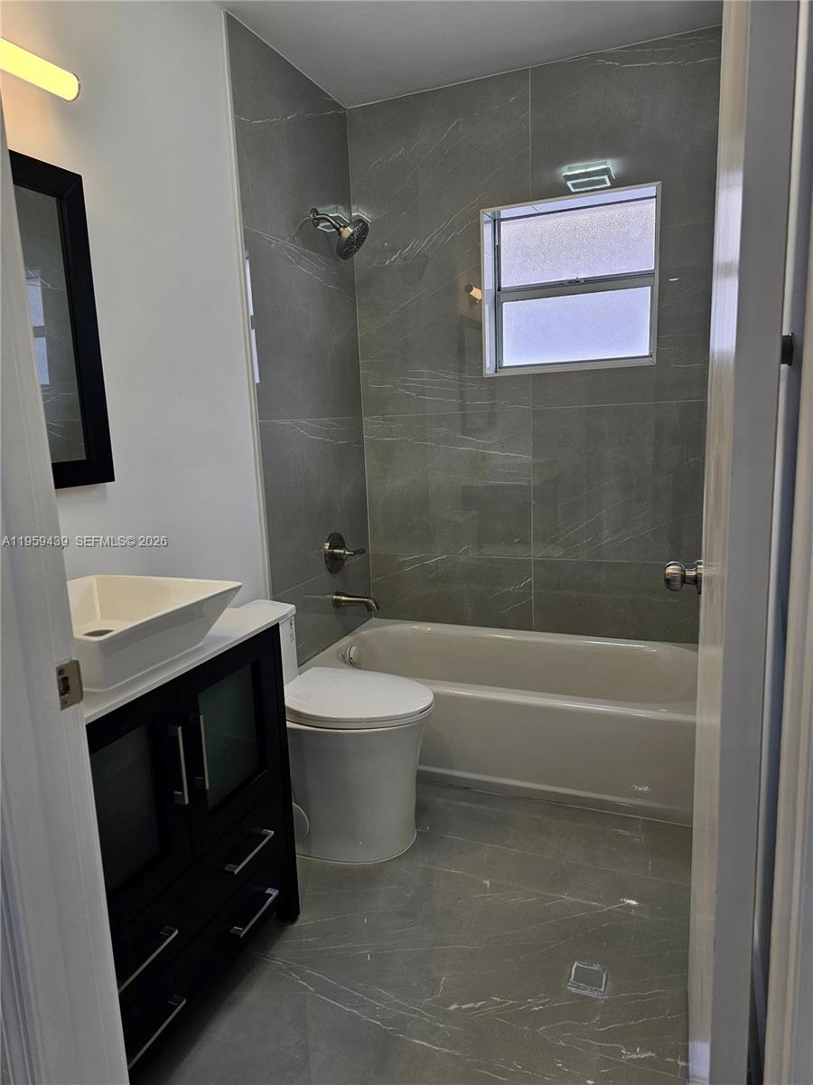 15581 Southwest 144th Court Miami, FL 33177 - Photo 17 of 37 a bathroom with a sink a toilet and shower