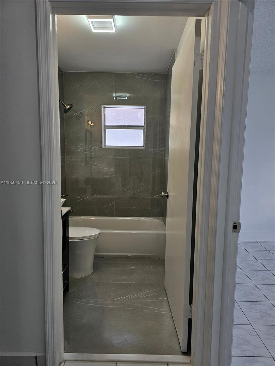 15581 Southwest 144th Court Miami, FL 33177 - Photo 19 of 37 a bathroom with a toilet and a bathtub