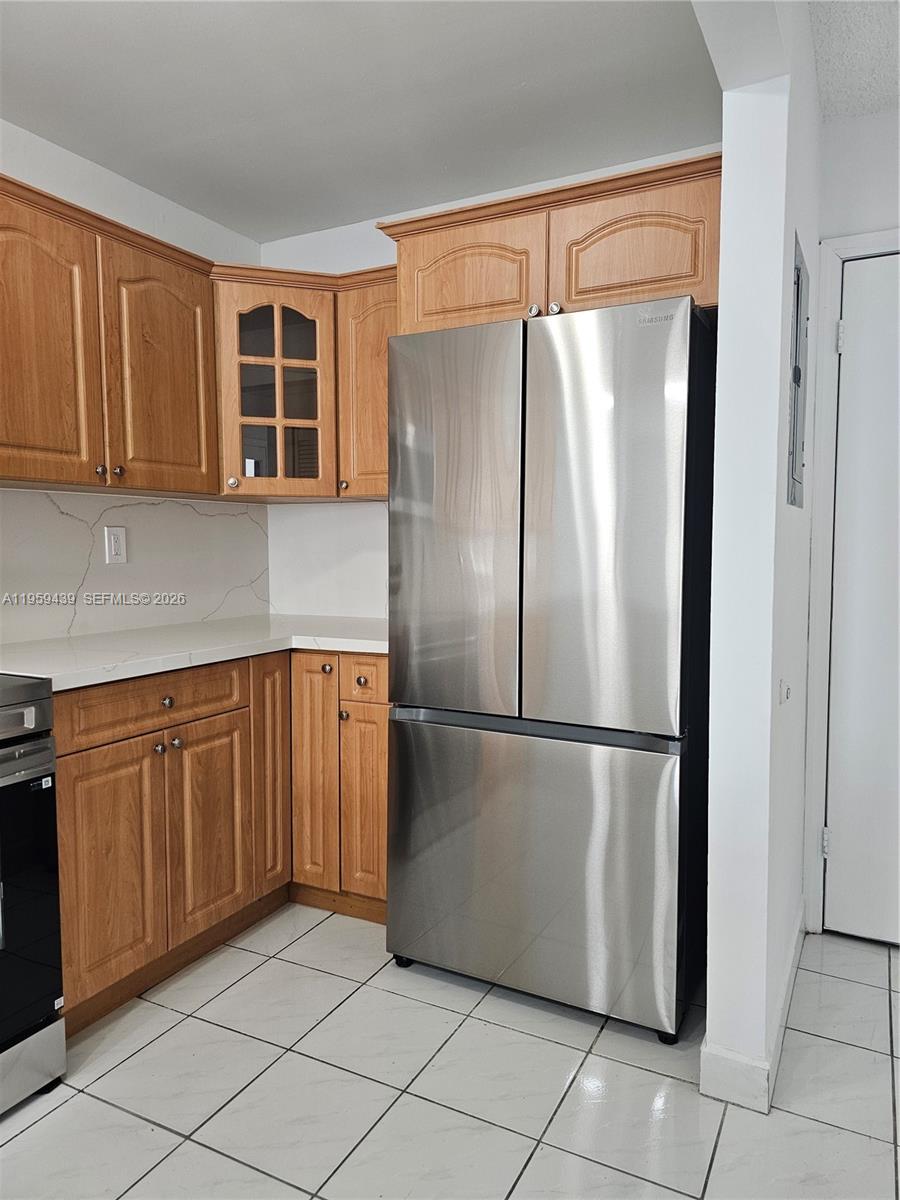 15581 Southwest 144th Court Miami, FL 33177 - Photo 25 of 37 a kitchen with stainless steel appliances granite countertop a refrigerator and a sink