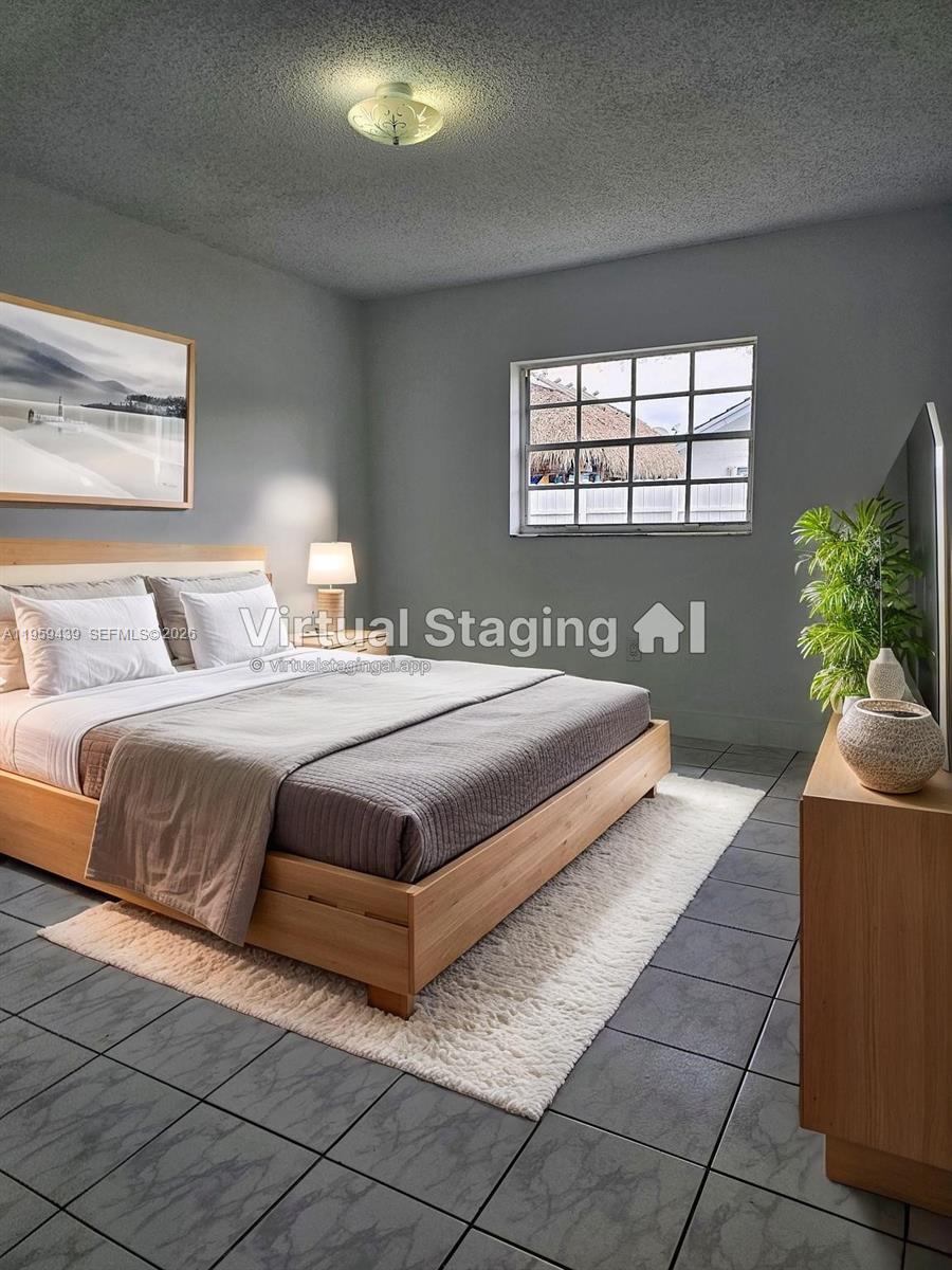 15581 Southwest 144th Court Miami, FL 33177 - Photo 28 of 37 a bedroom with a bed and window