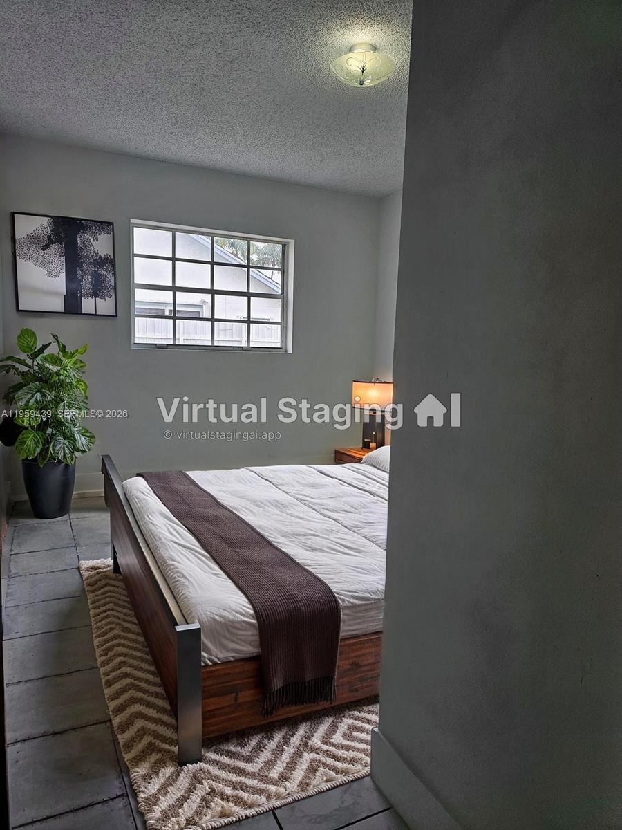 15581 Southwest 144th Court Miami, FL 33177 - Photo 29 of 37 a bedroom with a bed and a potted plant