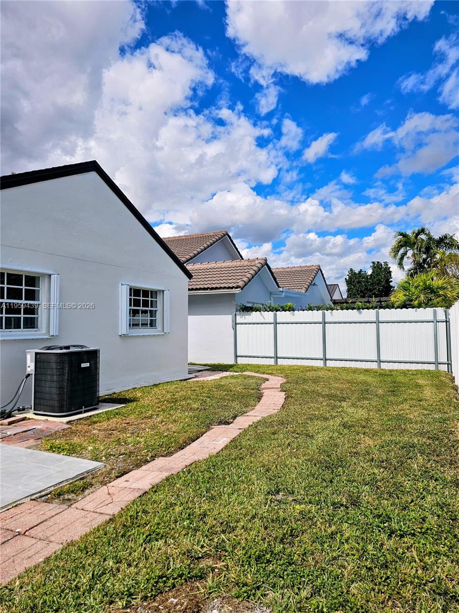 15581 Southwest 144th Court Miami, FL 33177 - Photo 33 of 37 a view of an house with backyard and trees