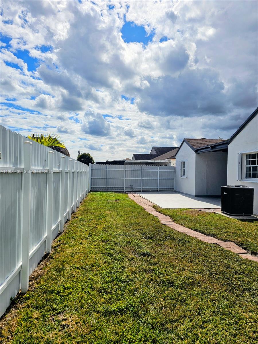 15581 Southwest 144th Court Miami, FL 33177 - Photo 34 of 37 a view of a backyard with a large tree