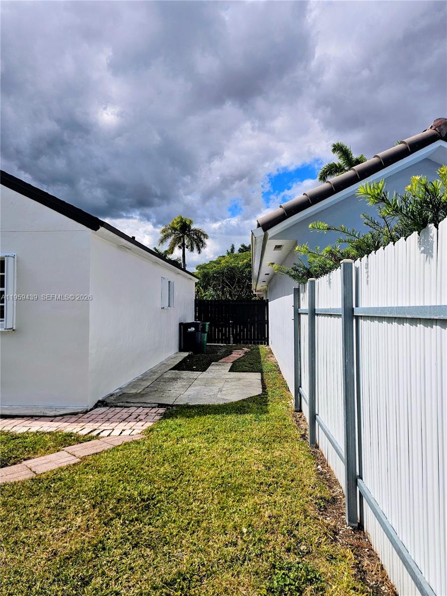 15581 Southwest 144th Court Miami, FL 33177 - Photo 35 of 37 a view of a yard with wooden fence
