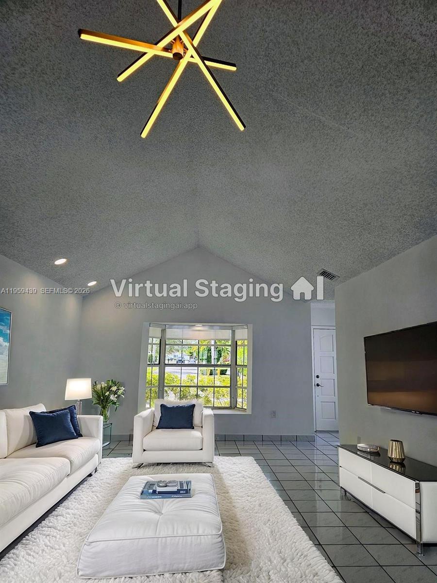 15581 Southwest 144th Court Miami, FL 33177 - Photo 6 of 37 a living room with furniture and a flat screen tv