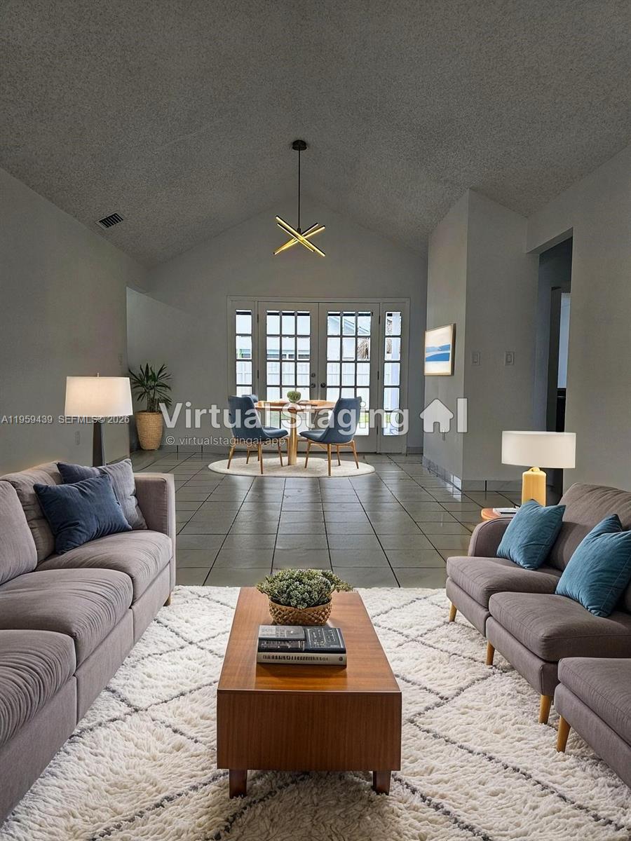 15581 Southwest 144th Court Miami, FL 33177 - Photo 7 of 37 a living room with furniture and a wooden floor