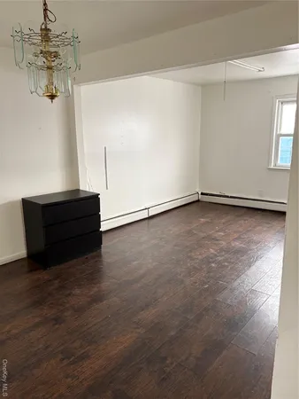 a view of a room with wooden floor and window