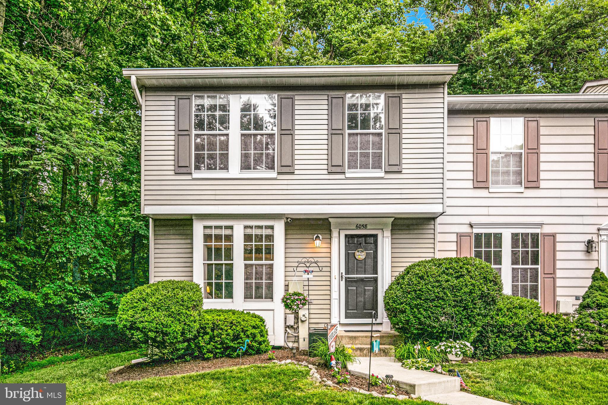 6058 Weekend Way, Unit G38 Columbia, MD 21044 - Photo 1 of 33 a front view of a house with a yard