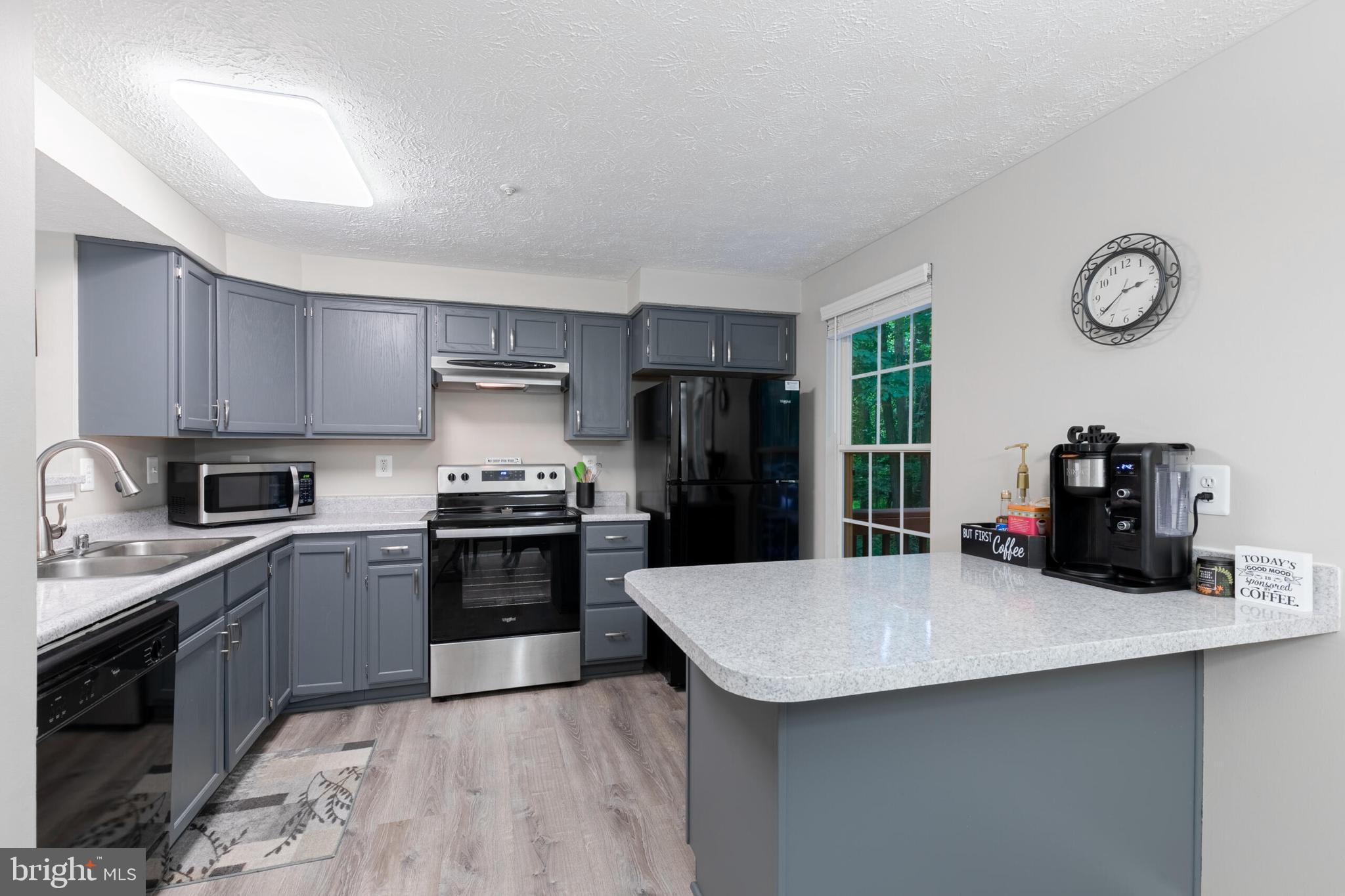 6058 Weekend Way, Unit G38 Columbia, MD 21044 - Photo 11 of 33 a kitchen with granite countertop a sink stove and refrigerator