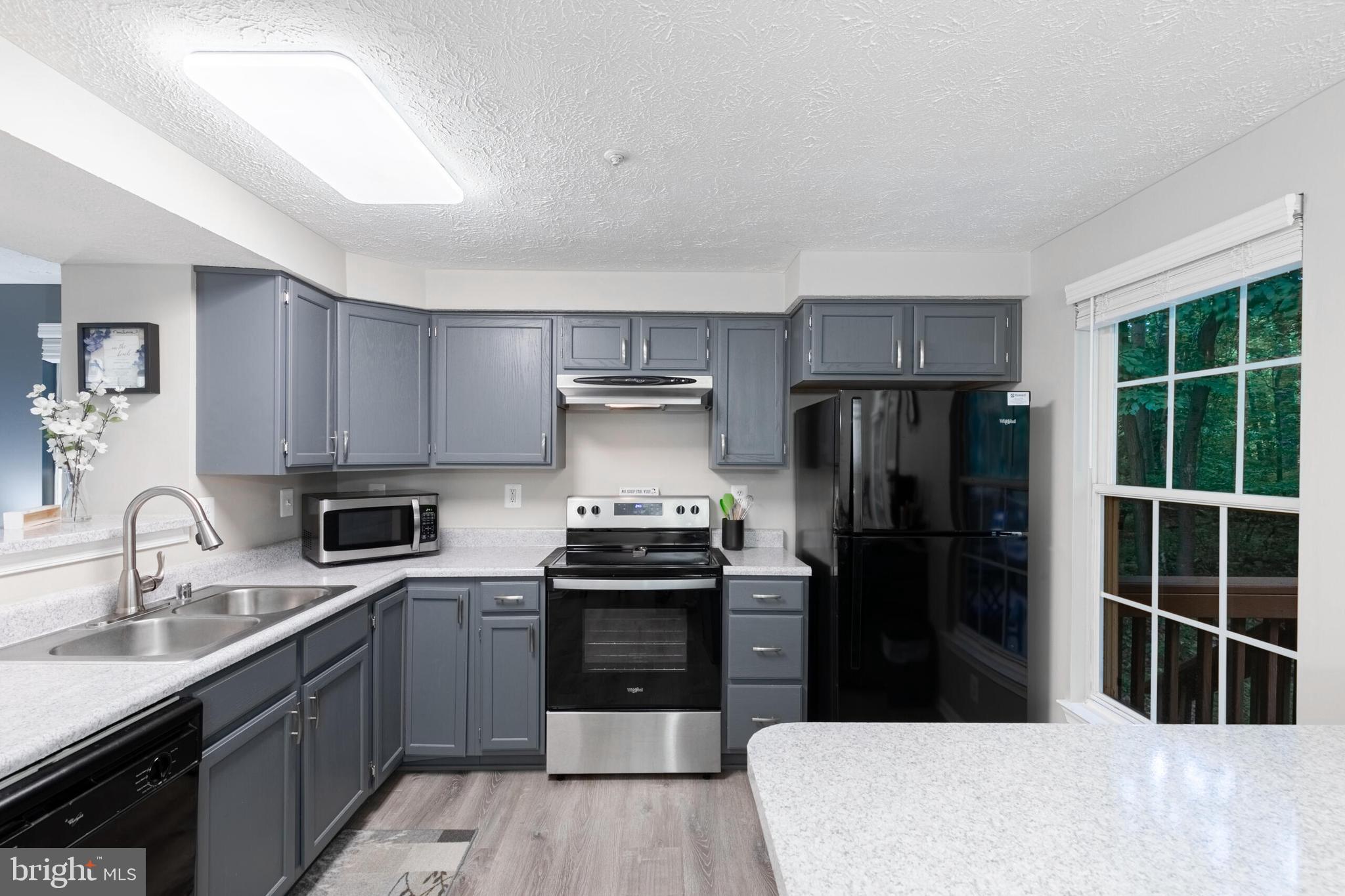 6058 Weekend Way, Unit G38 Columbia, MD 21044 - Photo 12 of 33 a kitchen with a refrigerator sink and stove