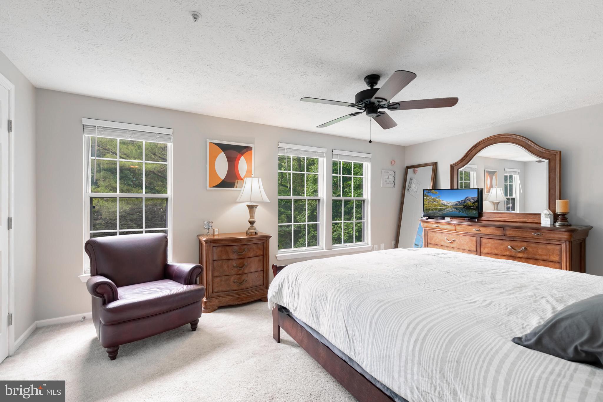 6058 Weekend Way, Unit G38 Columbia, MD 21044 - Photo 18 of 33 a bedroom with a large bed a chandelier and windows