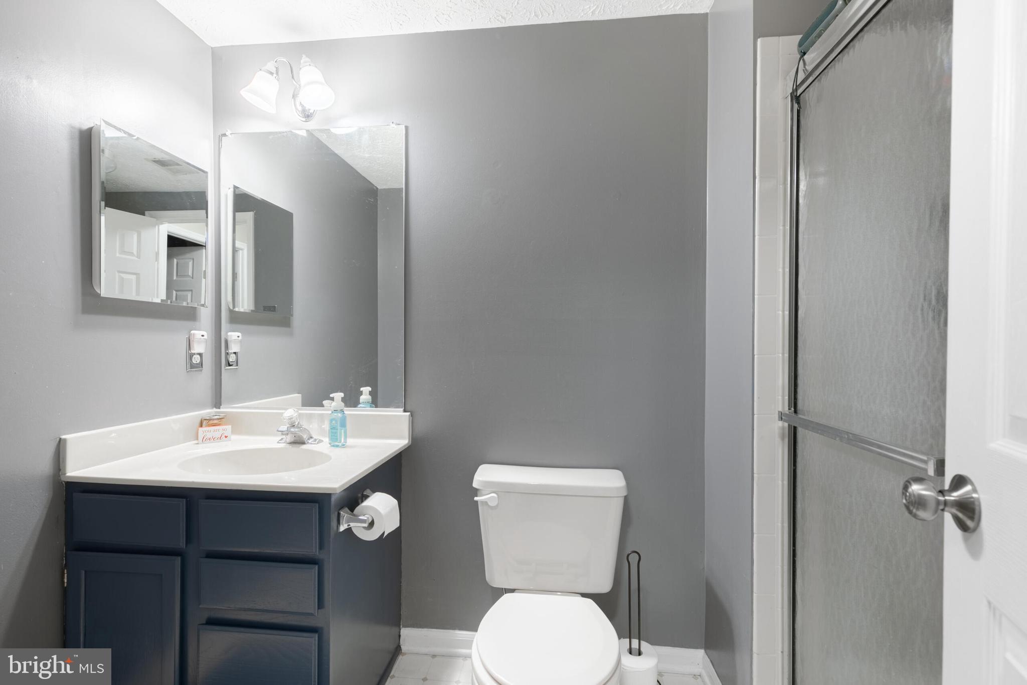 6058 Weekend Way, Unit G38 Columbia, MD 21044 - Photo 24 of 33 a bathroom with a toilet a sink and mirror