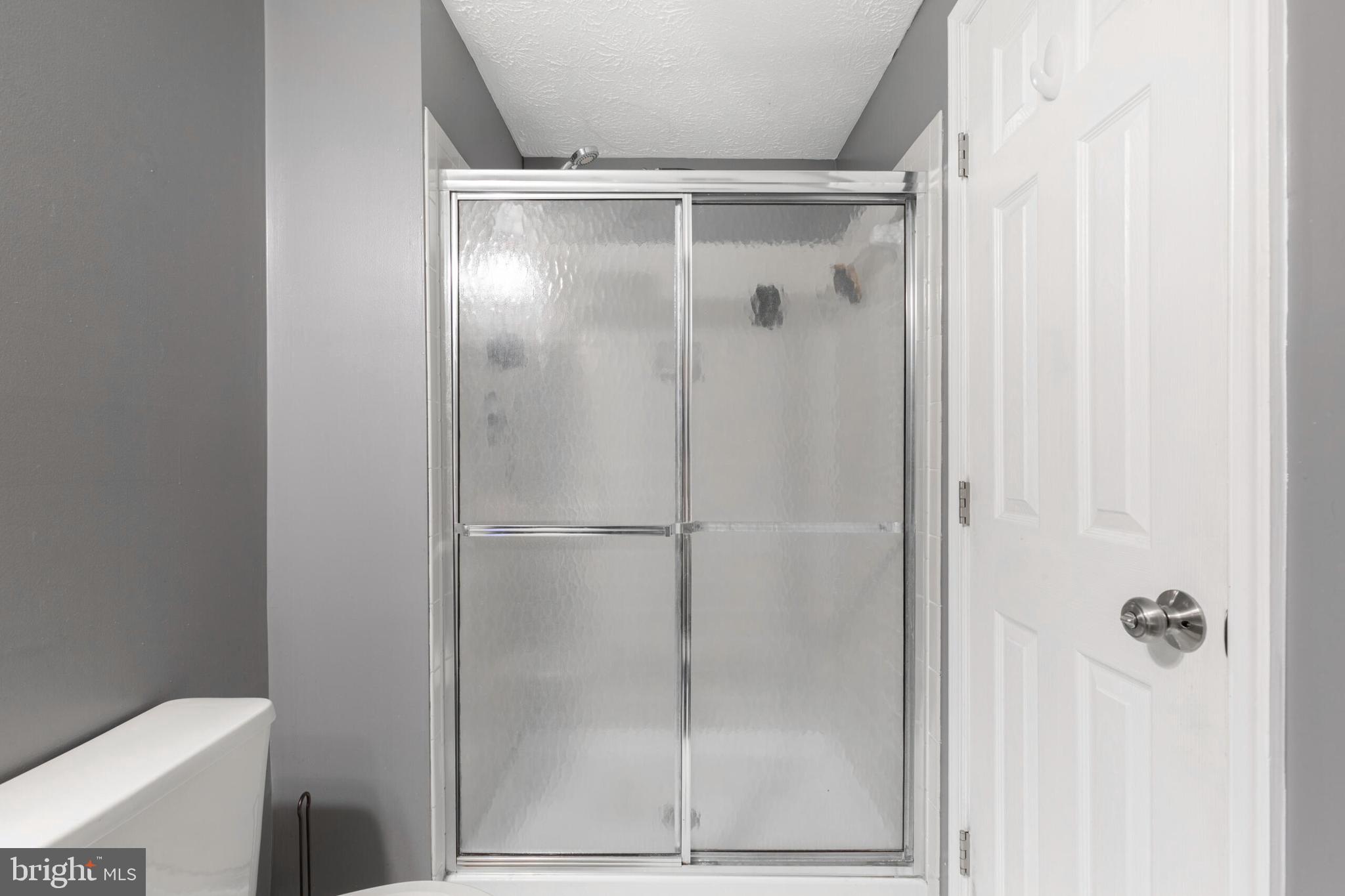 6058 Weekend Way, Unit G38 Columbia, MD 21044 - Photo 25 of 33 a bathroom with a glass shower door