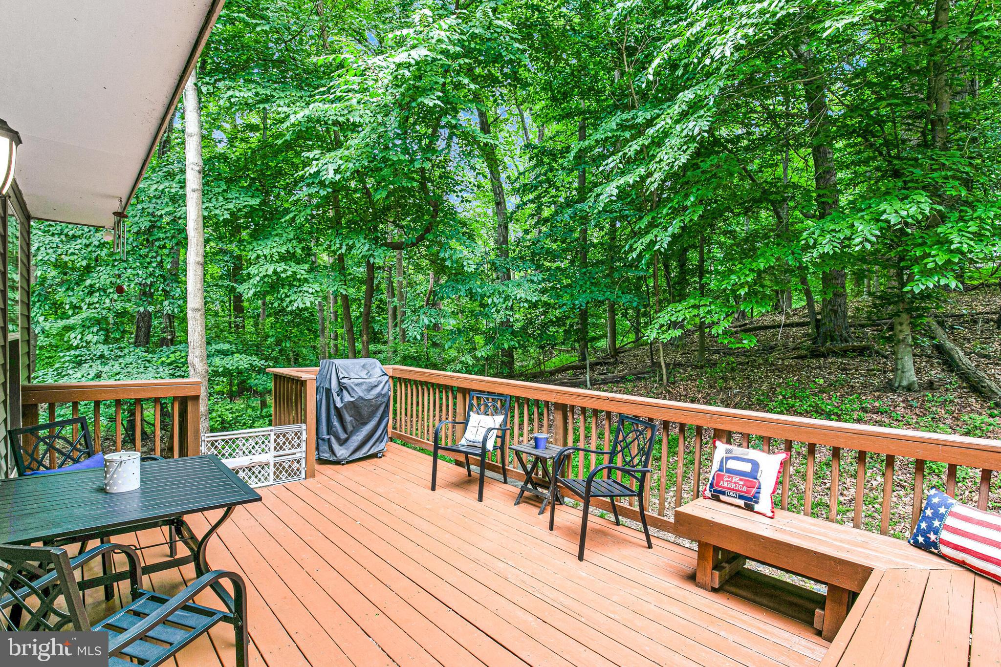 6058 Weekend Way, Unit G38 Columbia, MD 21044 - Photo 31 of 33 a view of a deck with furniture and trees