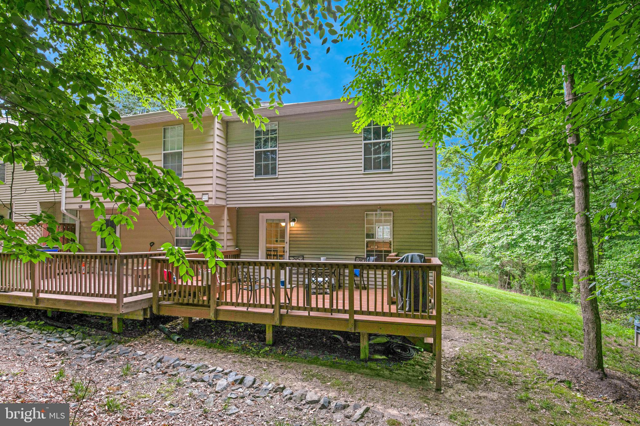 6058 Weekend Way, Unit G38 Columbia, MD 21044 - Photo 33 of 33 a view of a wooden deck with a bench and a yard