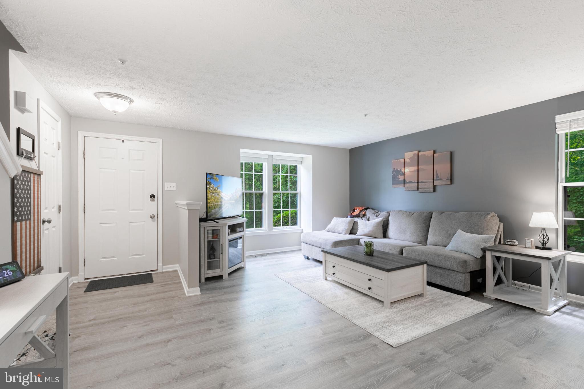 6058 Weekend Way, Unit G38 Columbia, MD 21044 - Photo 7 of 33 a living room with furniture and a flat screen tv