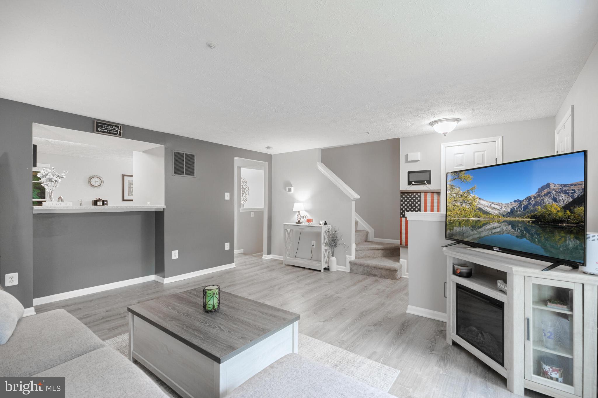 6058 Weekend Way, Unit G38 Columbia, MD 21044 - Photo 8 of 33 a living room with furniture and a flat screen tv