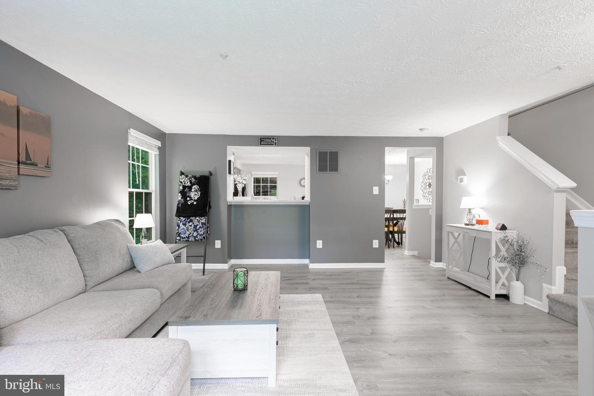 6058 Weekend Way, Unit G38 Columbia, MD 21044 - Photo 9 of 33 a living room with furniture and wooden floor