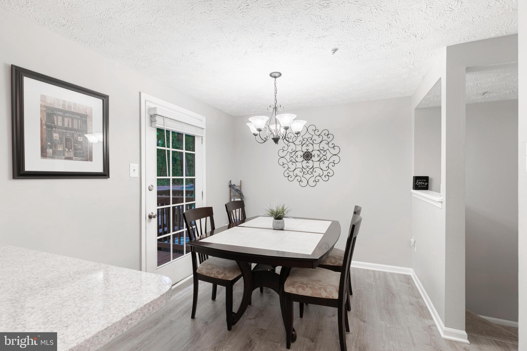 6058 Weekend Way, Unit G38 Columbia, MD 21044 - Photo 10 of 33 a view of a dining room with furniture and chandelier