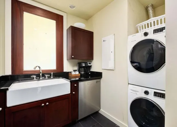 a utility room with sink dryer and washer