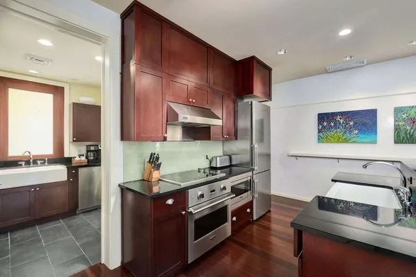 a kitchen with stainless steel appliances a stove a sink and a refrigerator