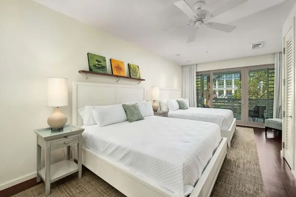 a bedroom with a bed and large window