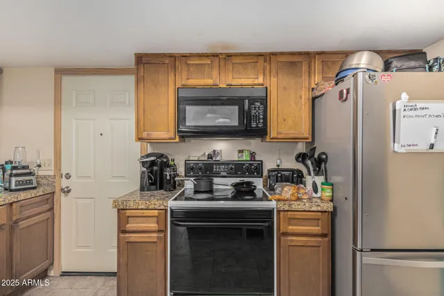 a kitchen with a refrigerator stove and microwave