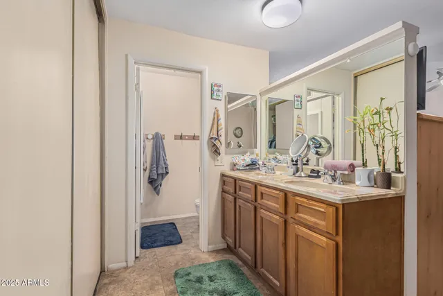 a bathroom with a double vanity sink mirror and shower